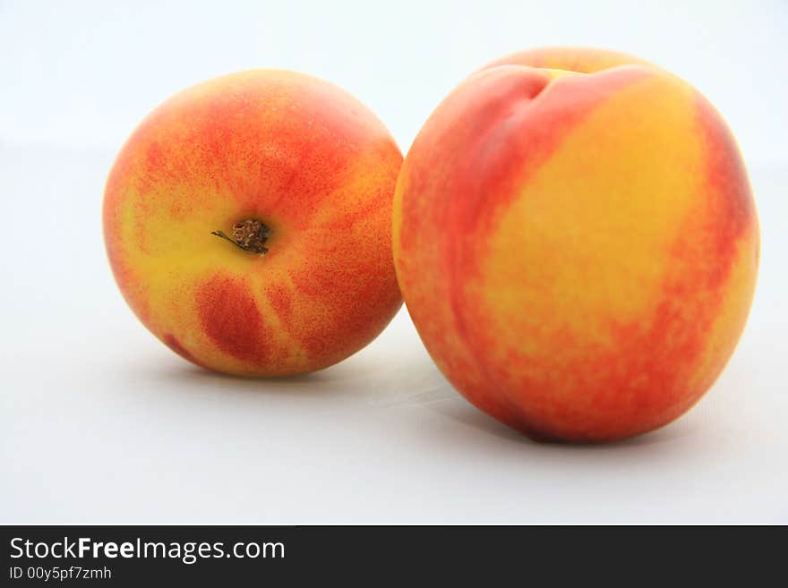 Some nectarines on white background