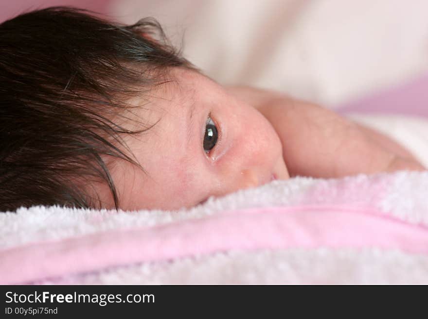 Little newborn caucasian girl lying