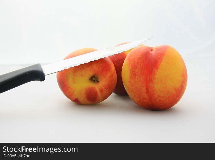 Some nectarines on white background