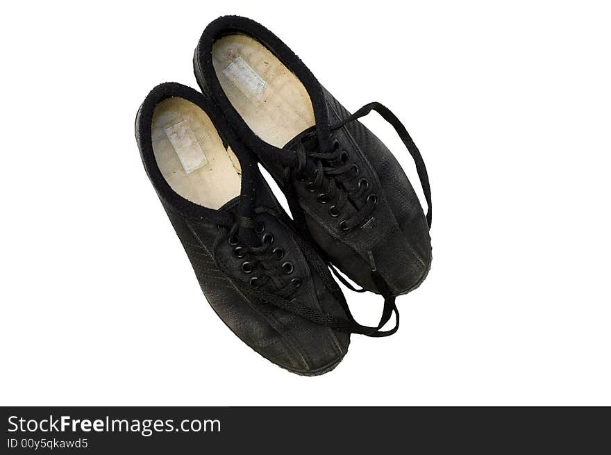 Worn black canvas fabric sneakers with black laces isolated against white background. Worn black canvas fabric sneakers with black laces isolated against white background