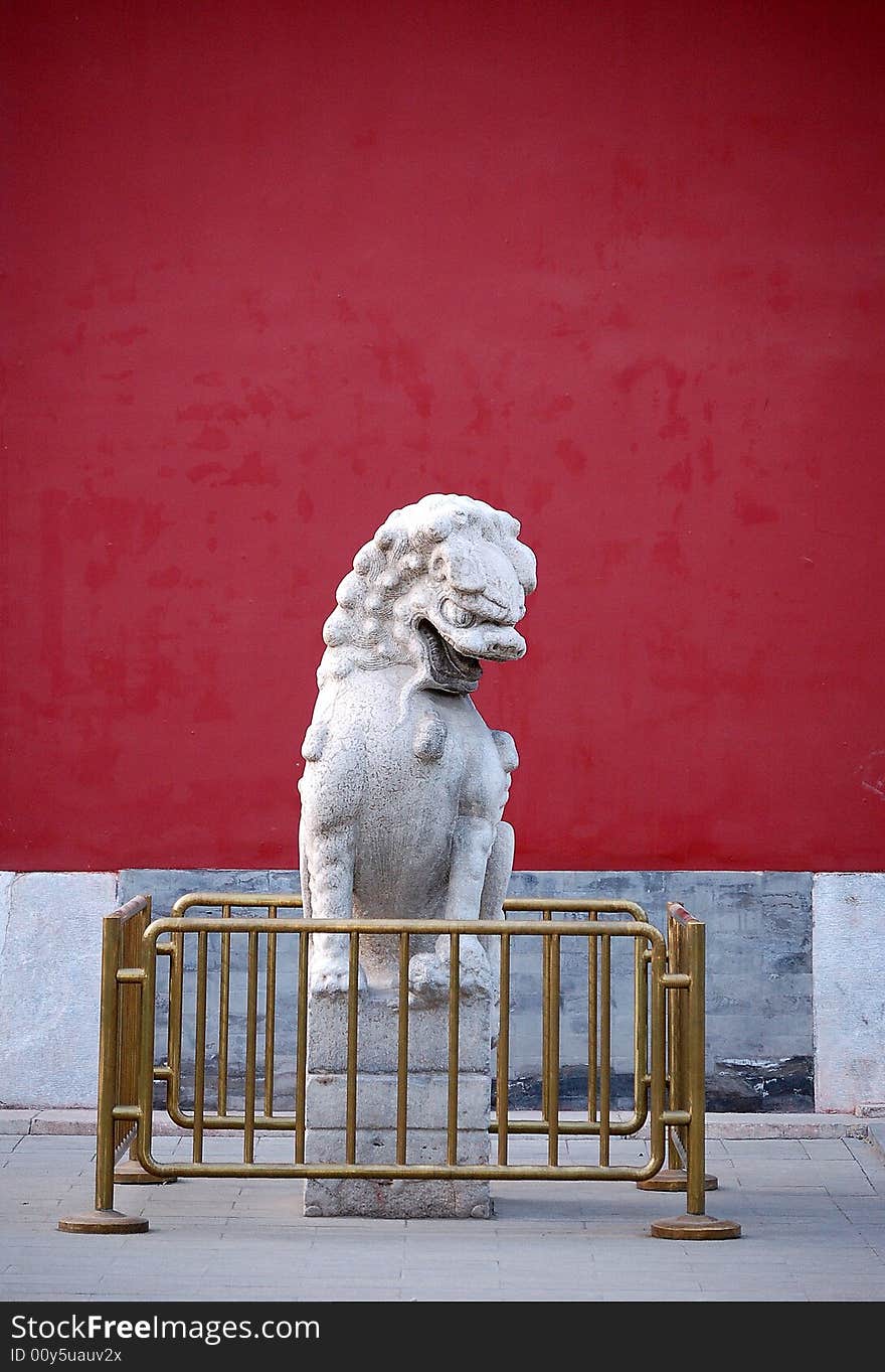 A traditional chinese stone lion sitting in the left side of the door, shot at Zhongshan park, Beijing China.