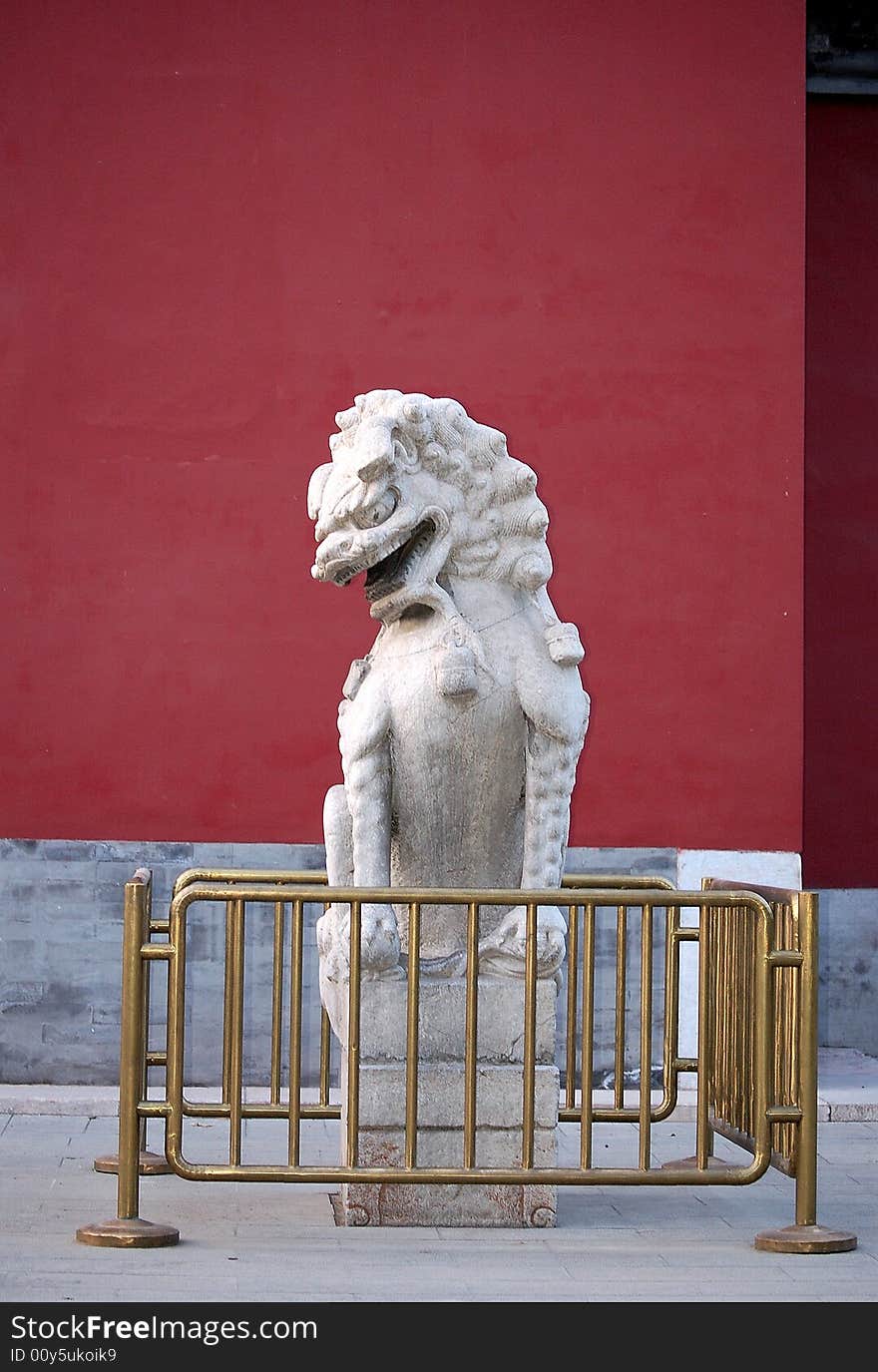 A traditional chinese stone lion sitting in the right side of the door, shot at Zhongshan park, Beijing China.