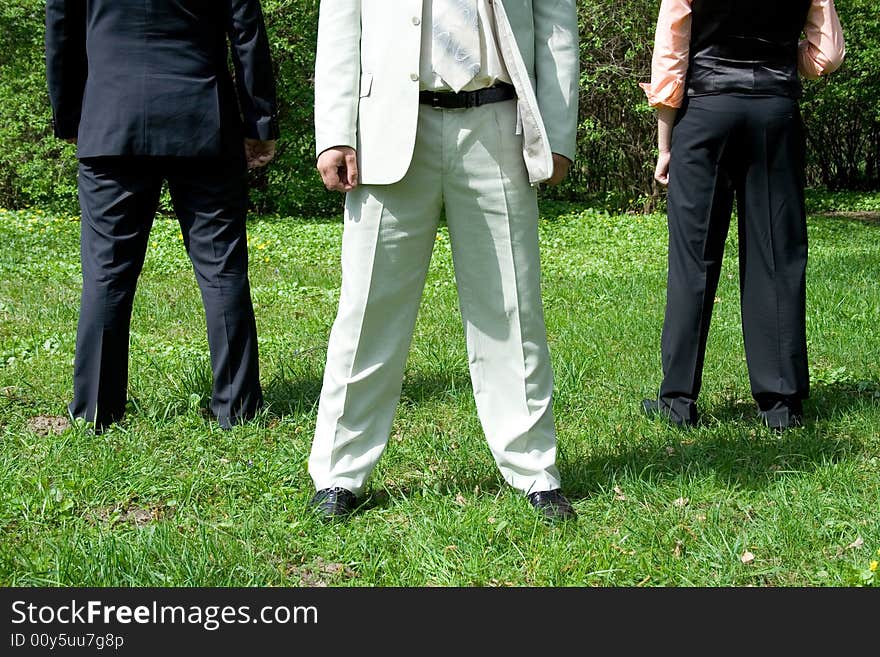 Groom with friends on the green grass