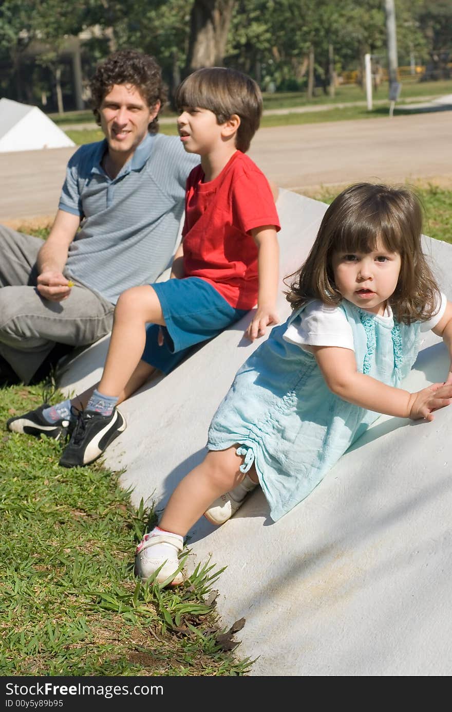 Family Sitting In Park