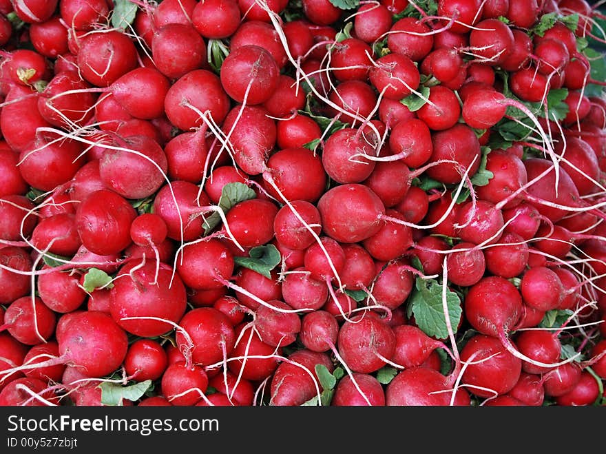 Pile of ripe radishes at a market. Pile of ripe radishes at a market.