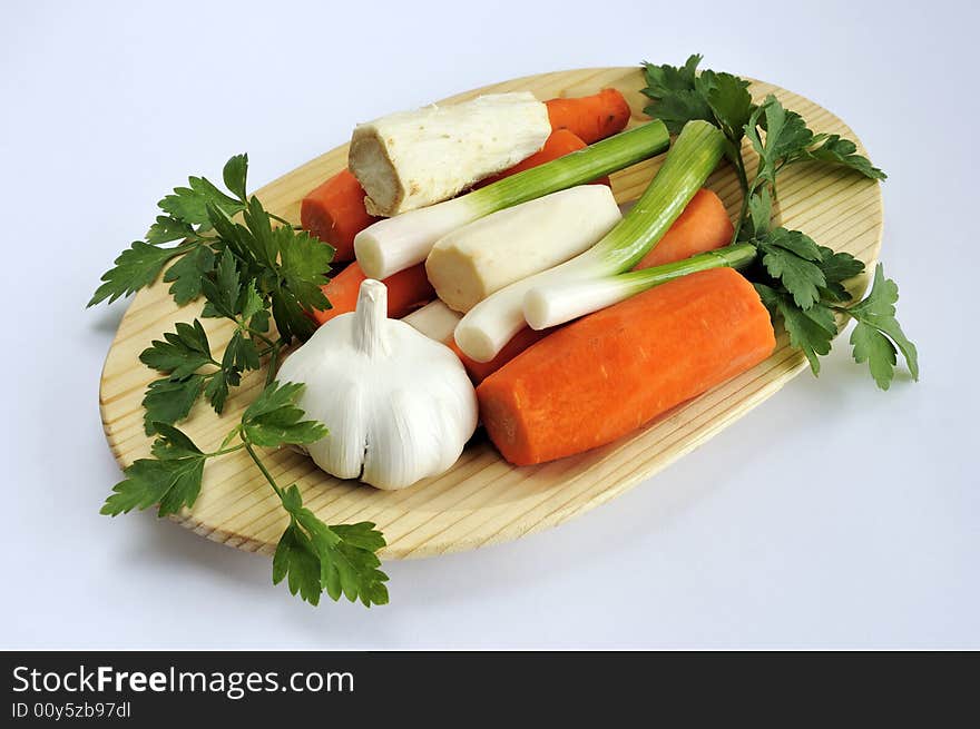 Assorted vegetables on a wooden plate