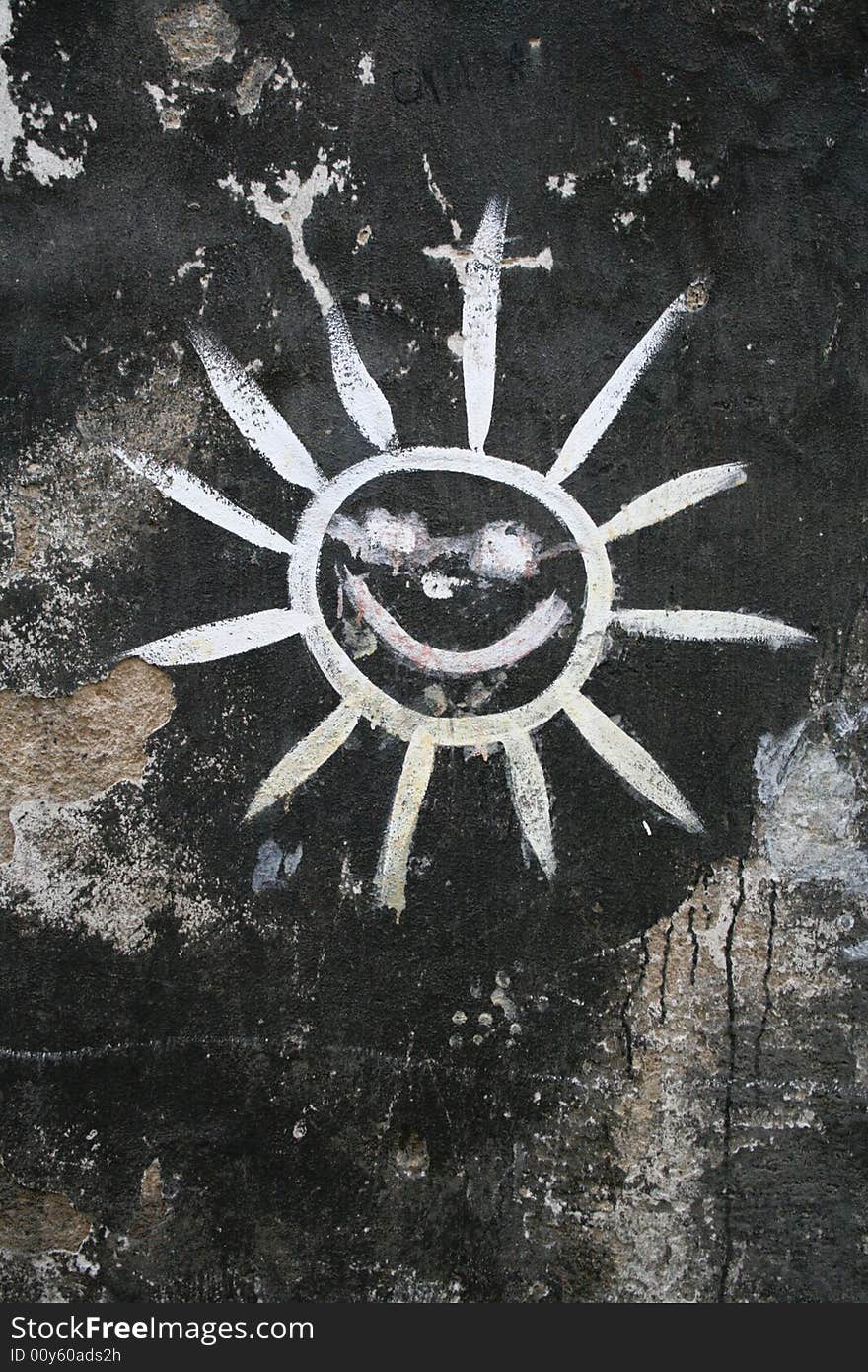 The painting of the sun on the old wall.