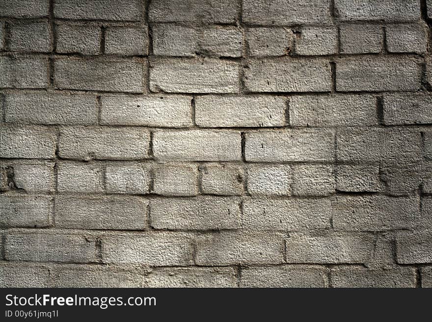 Aged grey brick wall background. Aged grey brick wall background