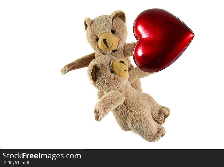 Two teddybears with red heart as symbol for love on white background as one of my isolated objects. Two teddybears with red heart as symbol for love on white background as one of my isolated objects