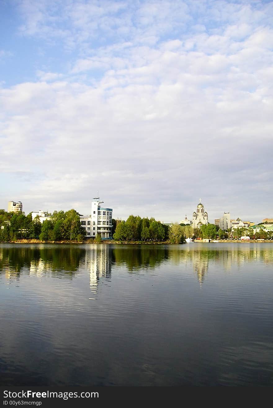 Coast of a city pond and the boundless blue sky