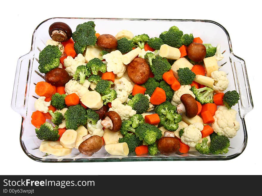 Baking dish with fresh chopped carrots, broccoli, cauliflower, parsnips and mushrooms. Baking dish with fresh chopped carrots, broccoli, cauliflower, parsnips and mushrooms.