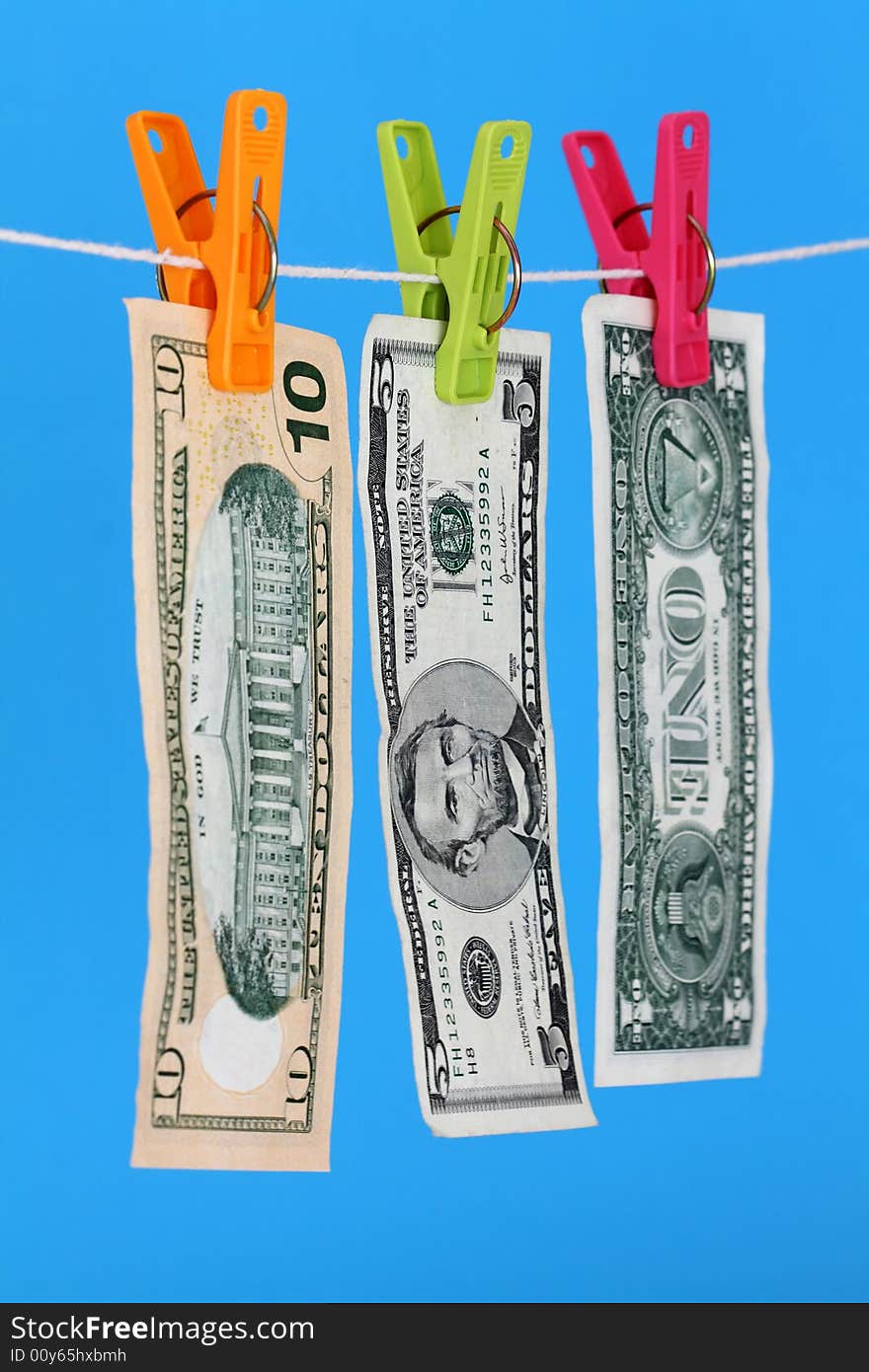 Three US dollar bills hanging on a washing line. Three US dollar bills hanging on a washing line