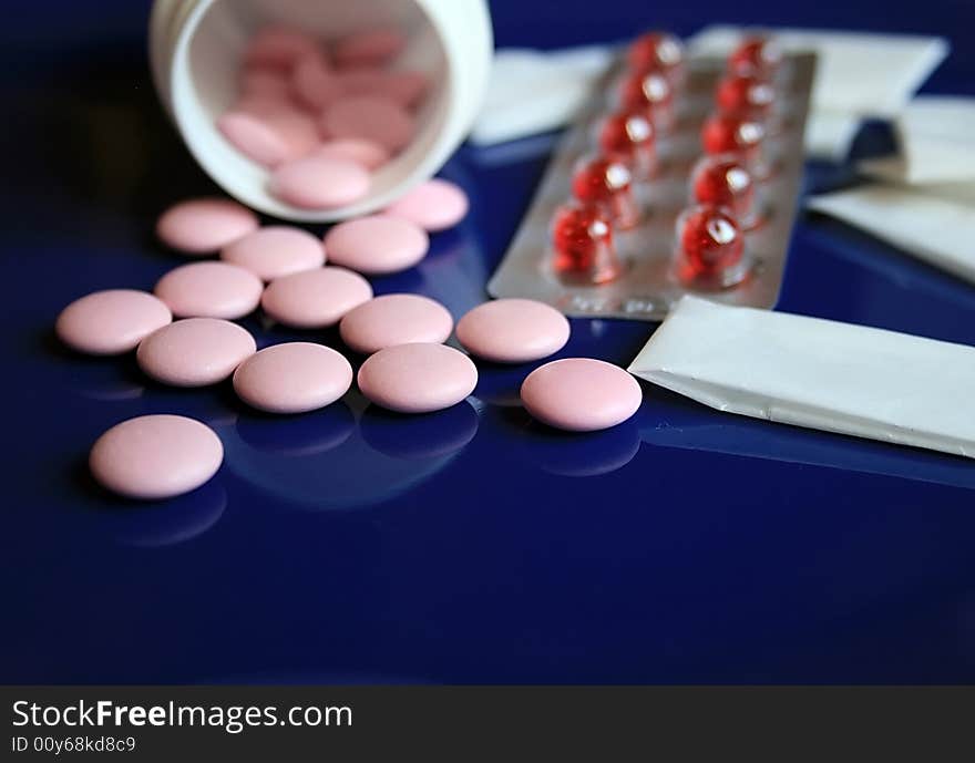 Tablets and pills on a dark blue background. Tablets and pills on a dark blue background.