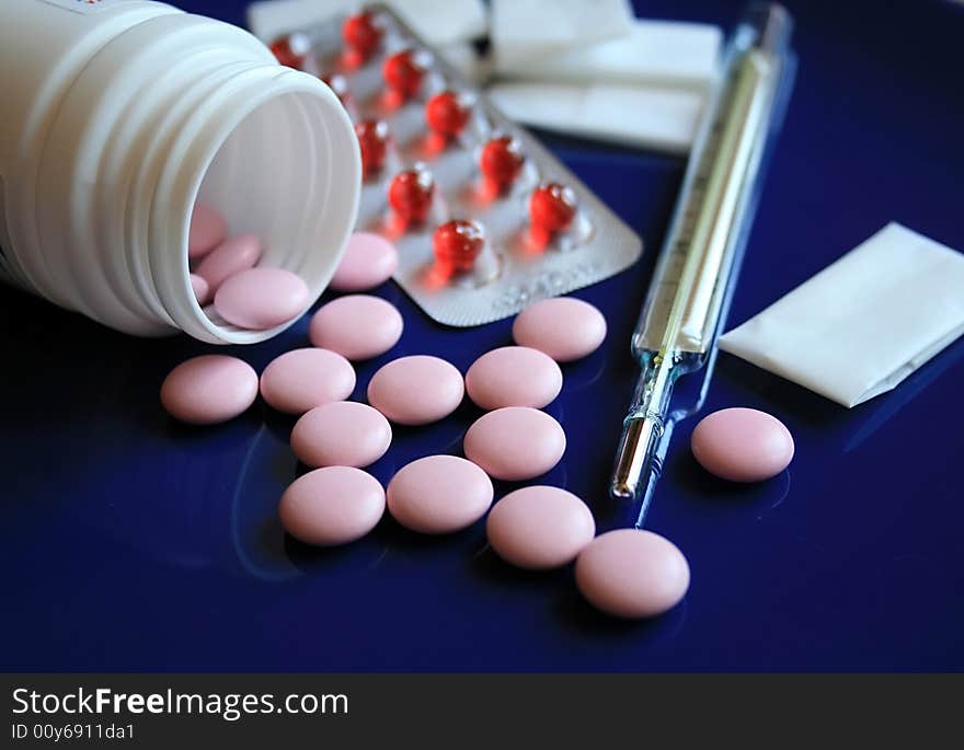 Tablets and pills on a dark blue background. Tablets and pills on a dark blue background.