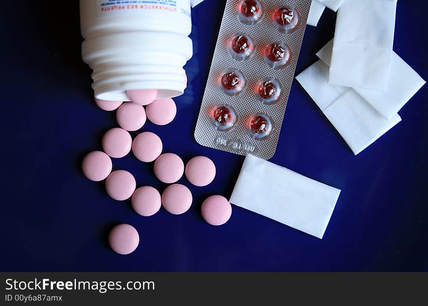 Tablets and pills on a dark blue background. Tablets and pills on a dark blue background.