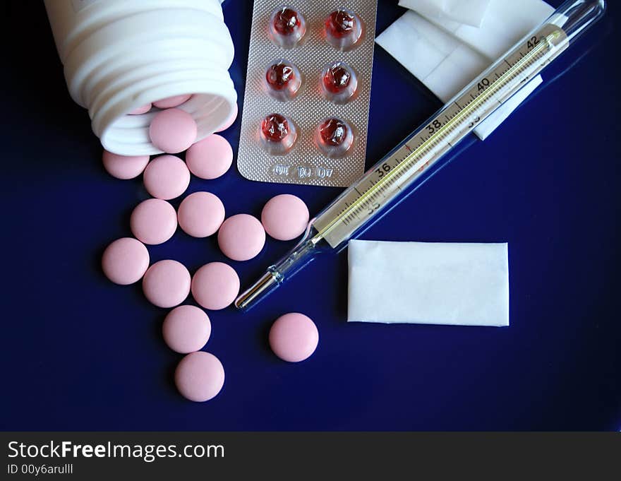 Tablets and pills on a dark blue background. Tablets and pills on a dark blue background.