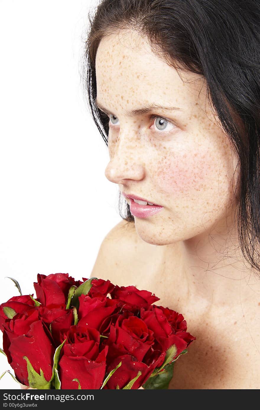 Beautiful brunette woman with a bunch of roses