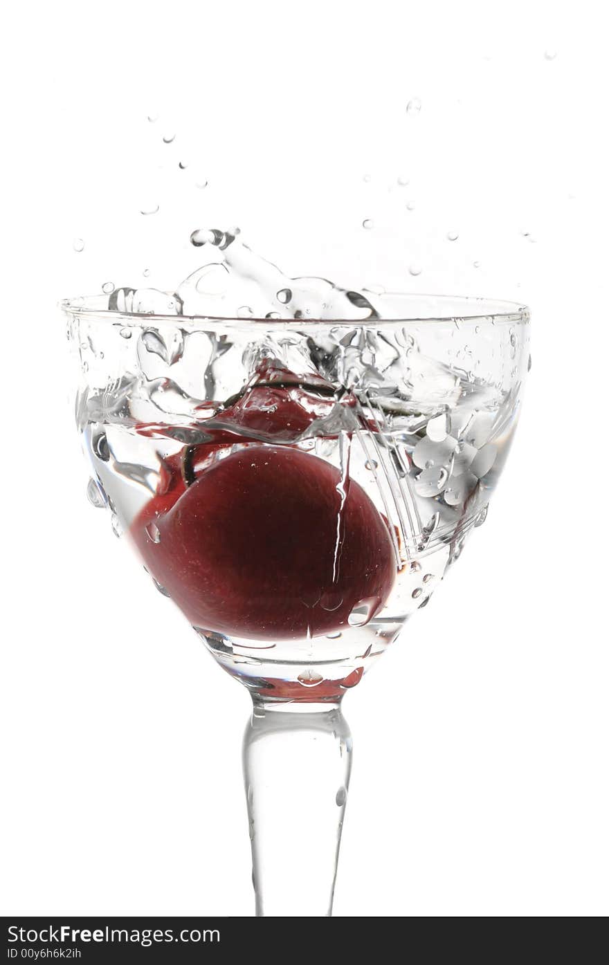 Cocktail with cherry falling into glass isolated on white. Cocktail with cherry falling into glass isolated on white