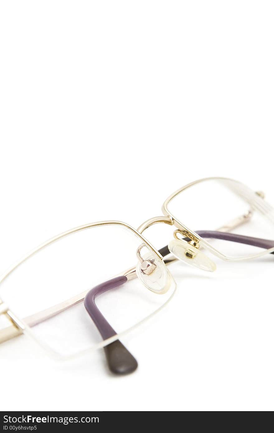 Glasses in a gold frame on a white background. Glasses in a gold frame on a white background