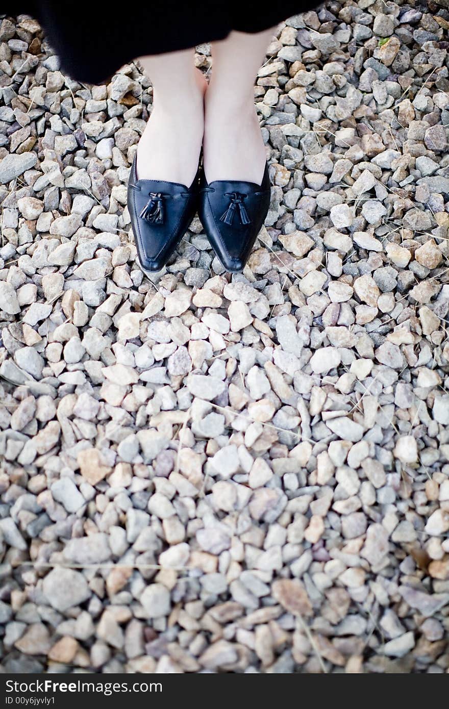 Close view of businesswoman formal shoes on rocks. Close view of businesswoman formal shoes on rocks