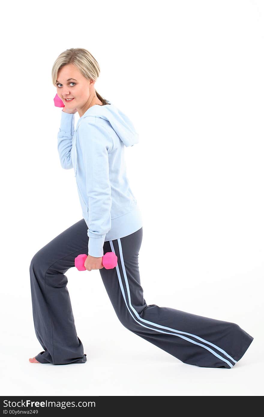 Blond woman in gym outfit exercising with a pilates ball isolated on white