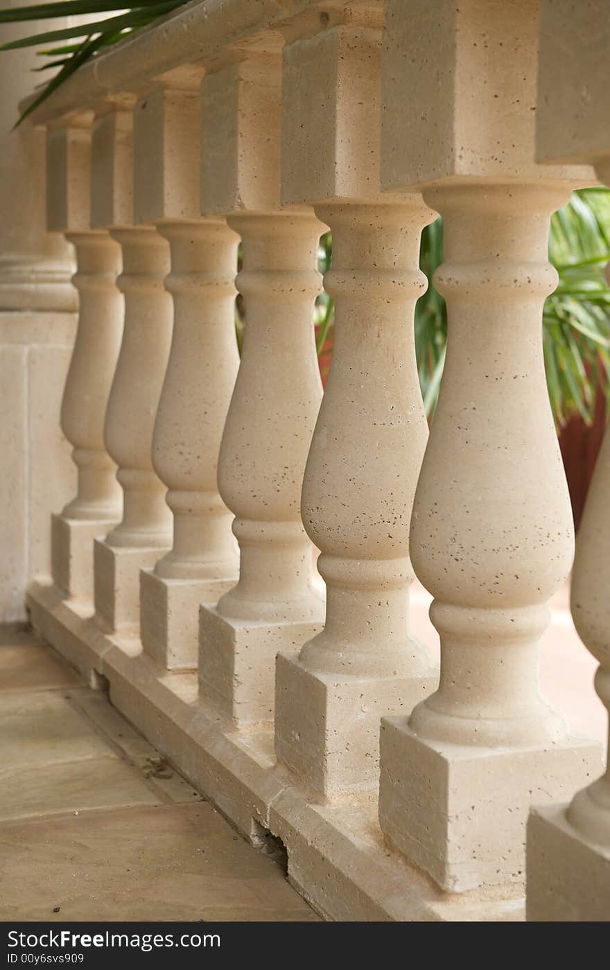 An abstract image of an upscale patio's luxurious pillar railing