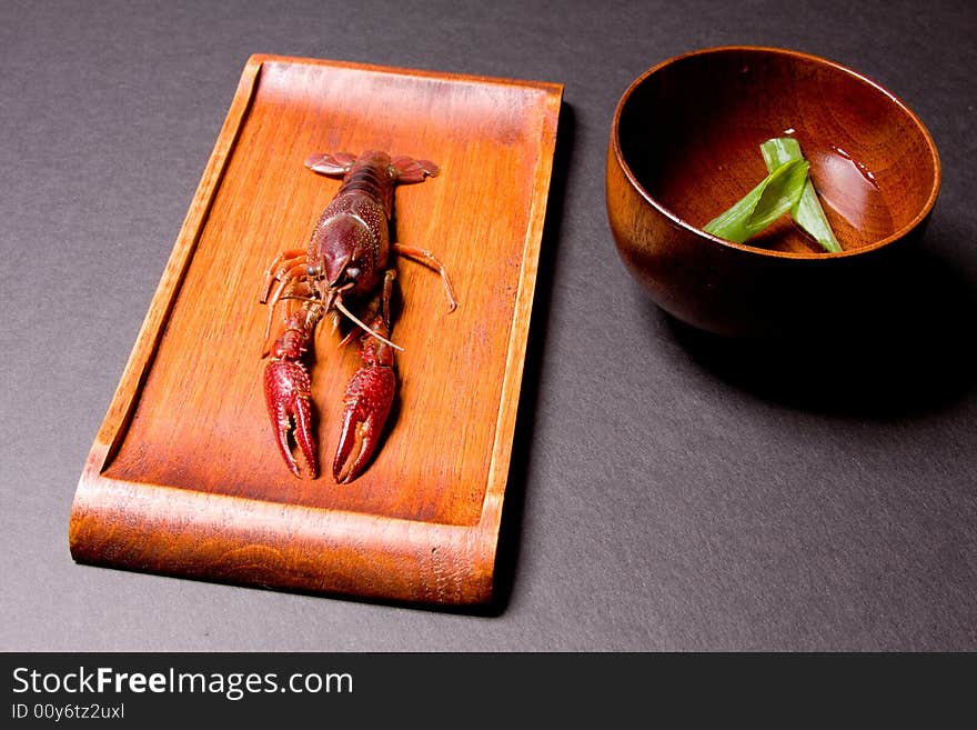 Seafood crawfish in a wooden plate. Seafood crawfish in a wooden plate.