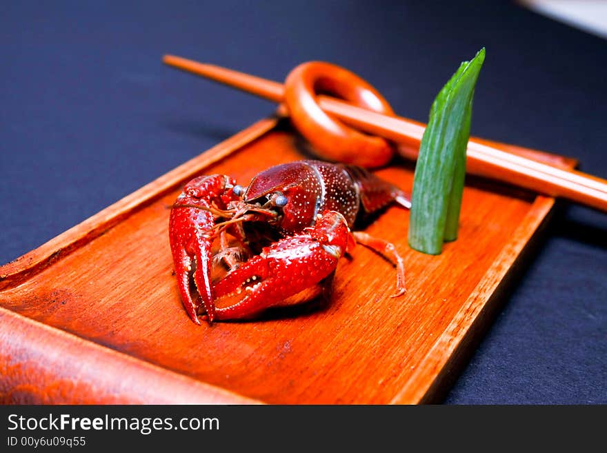 Seafood crawfish in a wooden plate. Seafood crawfish in a wooden plate.