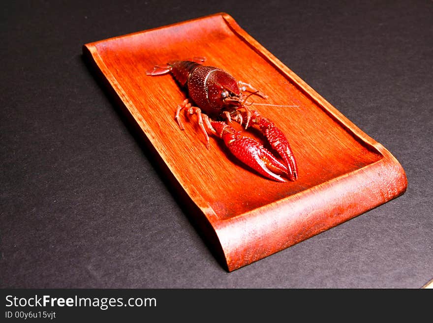 Seafood crawfish in a wooden plate.