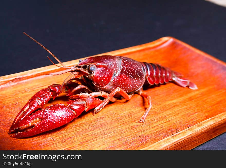 Seafood crawfish in a wooden plate. Seafood crawfish in a wooden plate.