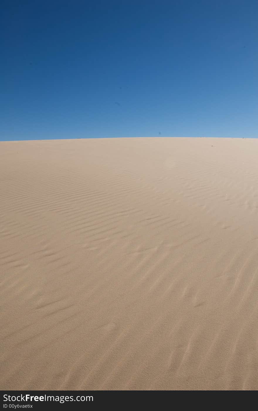 Sand dunes with a blue sky