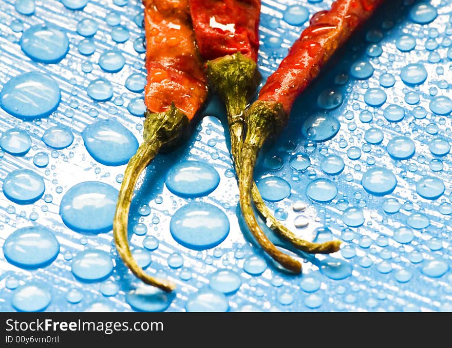 Dried red chili peppers and water drops. Dried red chili peppers and water drops.