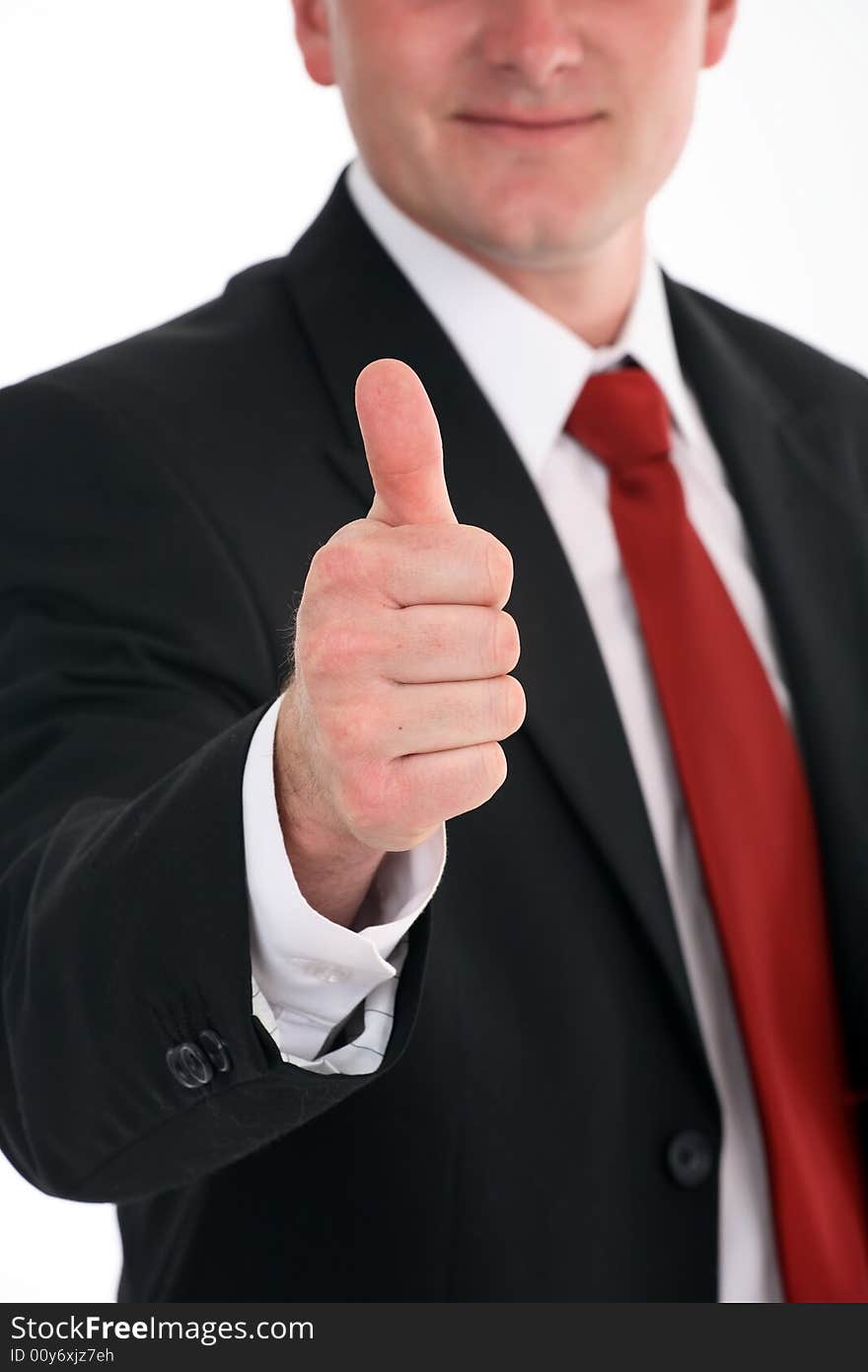 Portrait of a young attractive businessman giving the thumbs-up sign. Portrait of a young attractive businessman giving the thumbs-up sign.