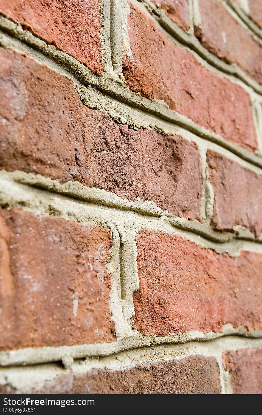 Aged red brick wall with distressed surface