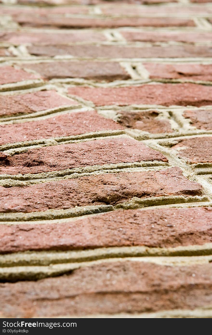 Aged red brick wall with distressed surface