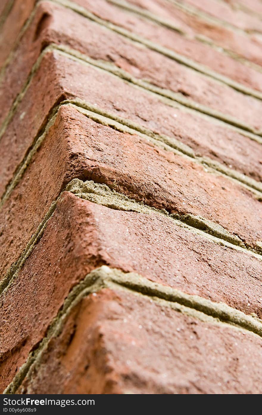 Aged red brick wall with distressed surface