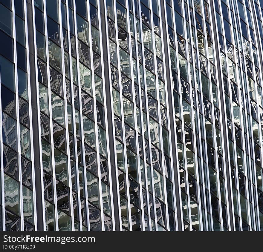 A bright sunny day creates wonderful reflections on the side of a highrise. A bright sunny day creates wonderful reflections on the side of a highrise.