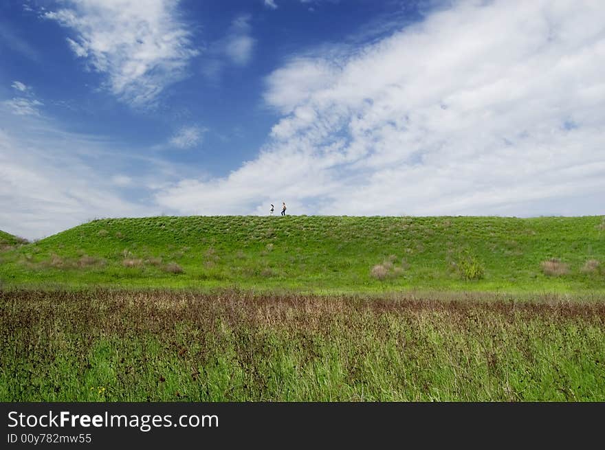 Spring landscape with two traveller