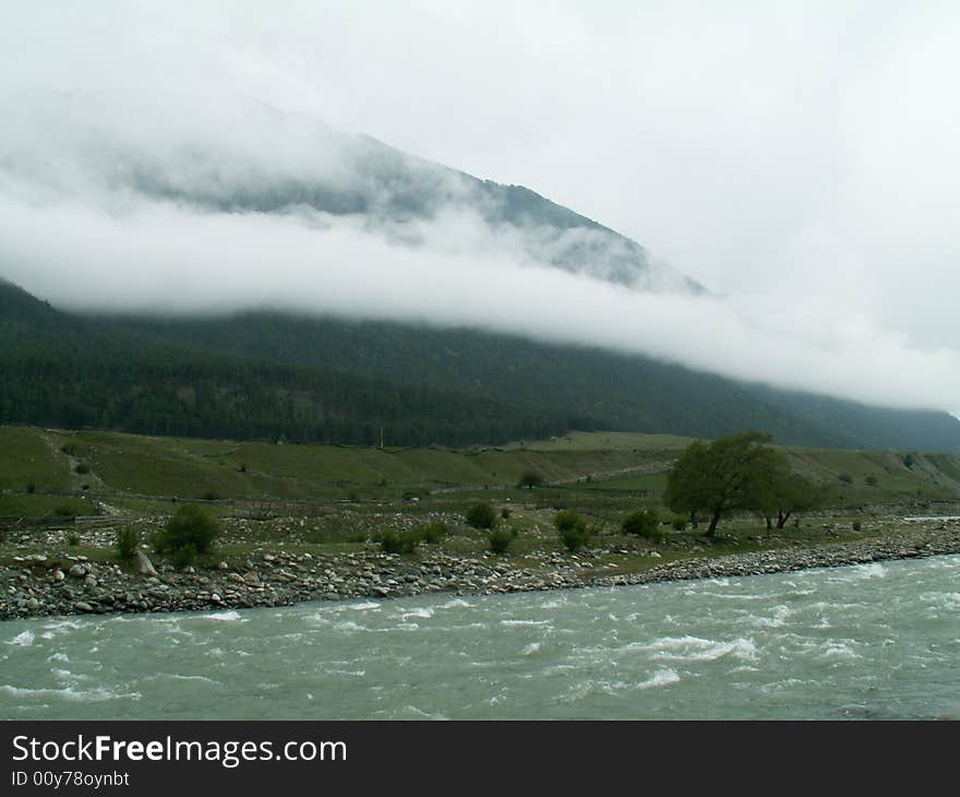 River, mountins on the background in the clouds. River, mountins on the background in the clouds