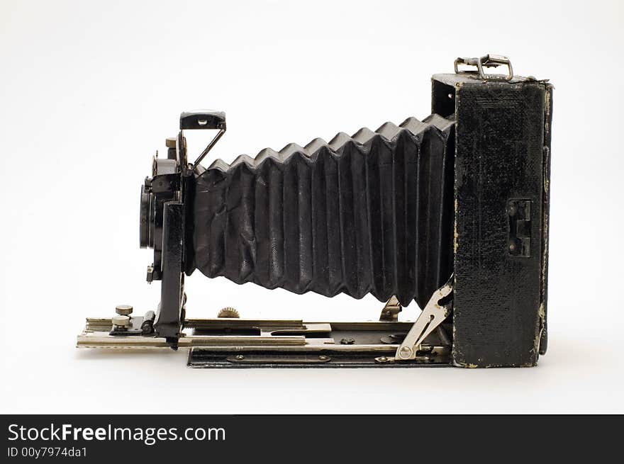 The old photographic chamber with a lens of furs on a white background. The old photographic chamber with a lens of furs on a white background.