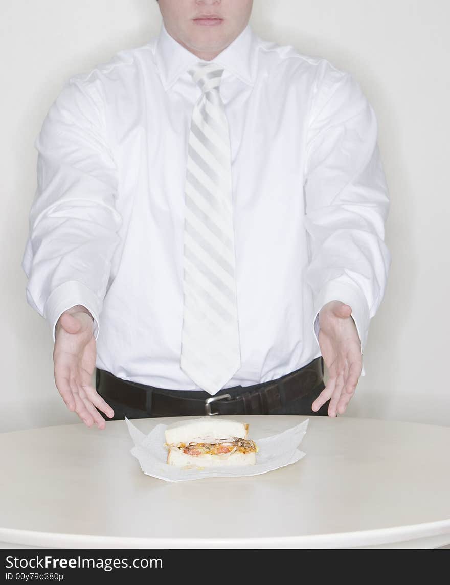 Businessman presenting sandwich