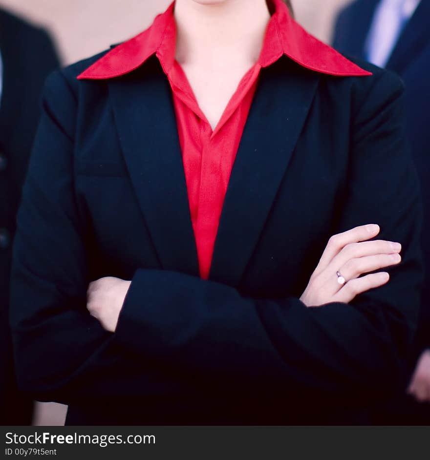 Businesswoman standing with two businessmen behind her