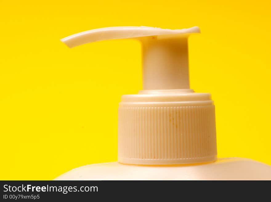 Cleaning supplies on yellow background