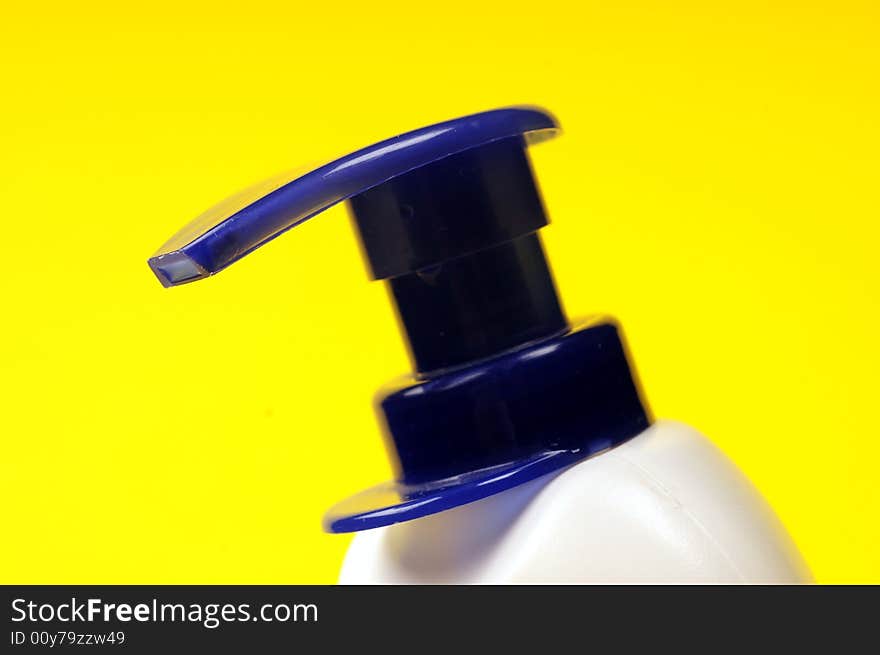 Cleaning supplies on yellow background