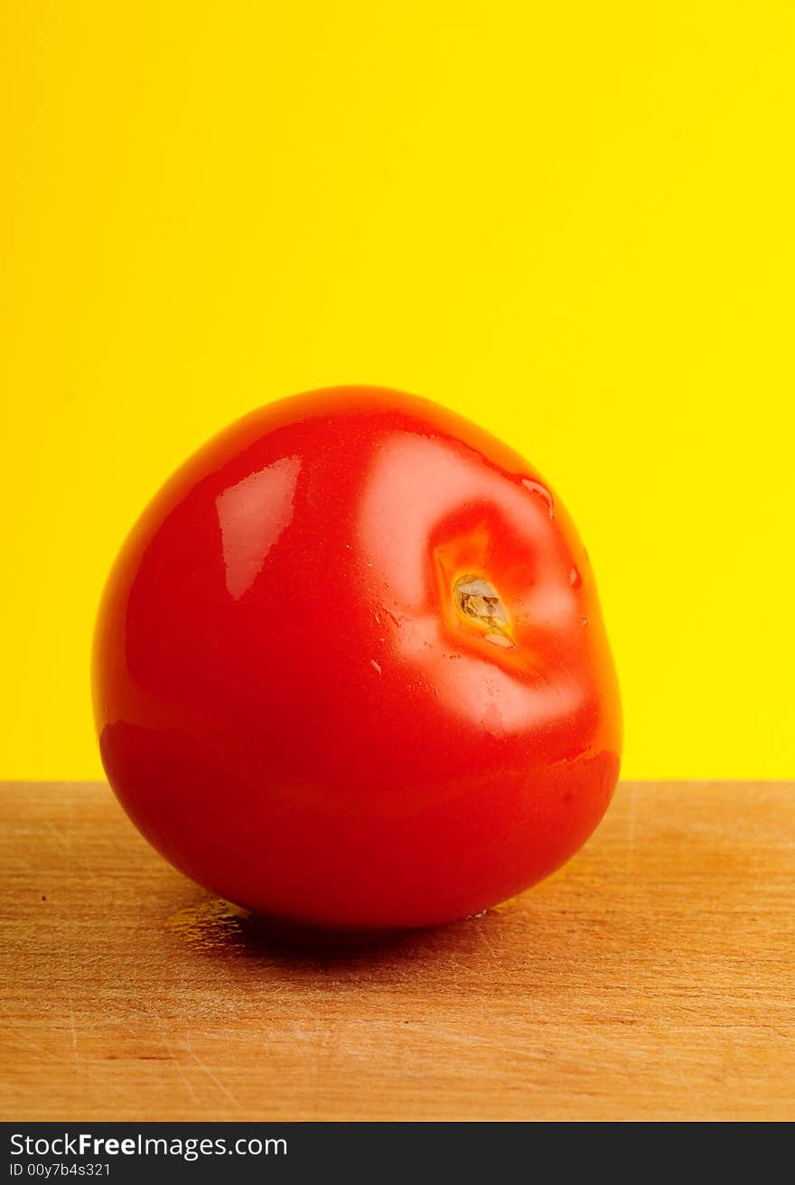 Tomato isolated on yellow background