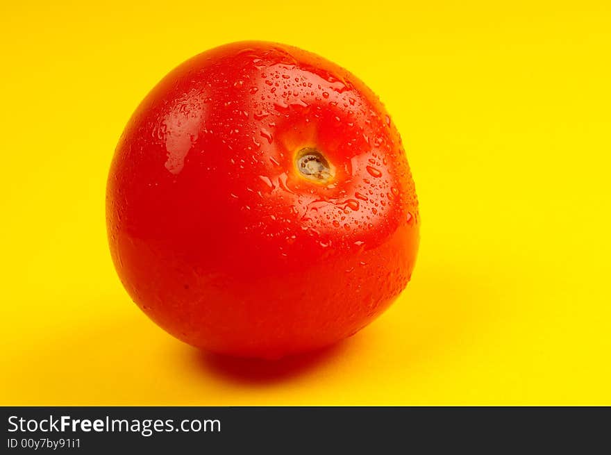 Tomato isolated on yellow background