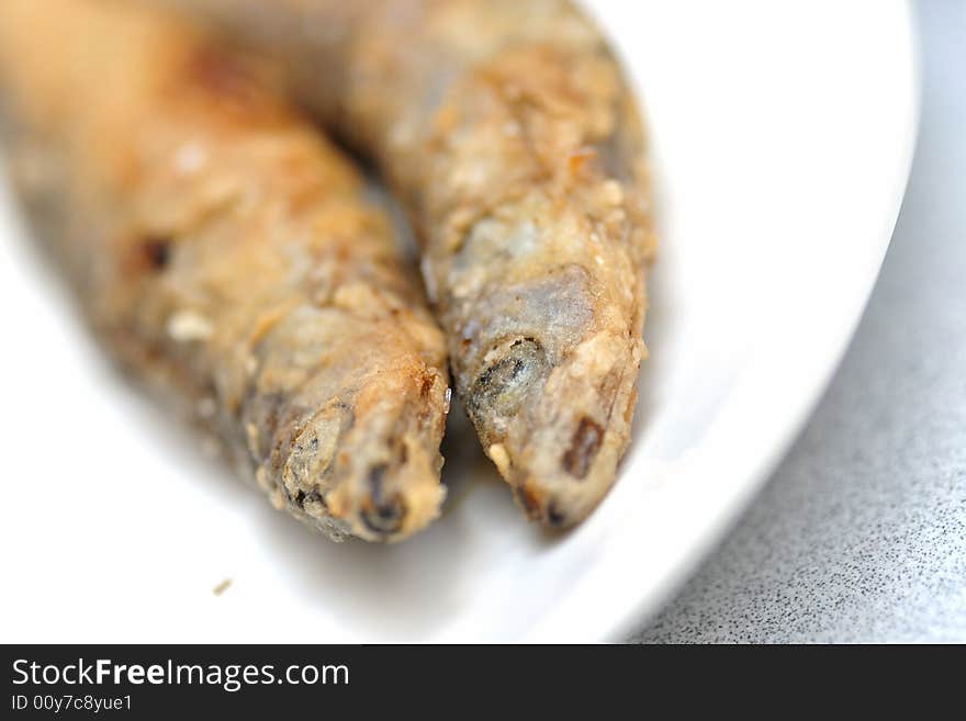 Shishamo sushi served on white plate