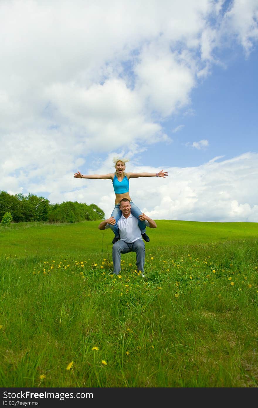 Young family jumping on a lawn