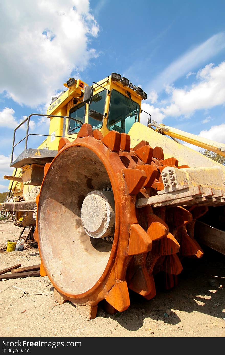 Heavy dump truck against blue sky operating in a sand