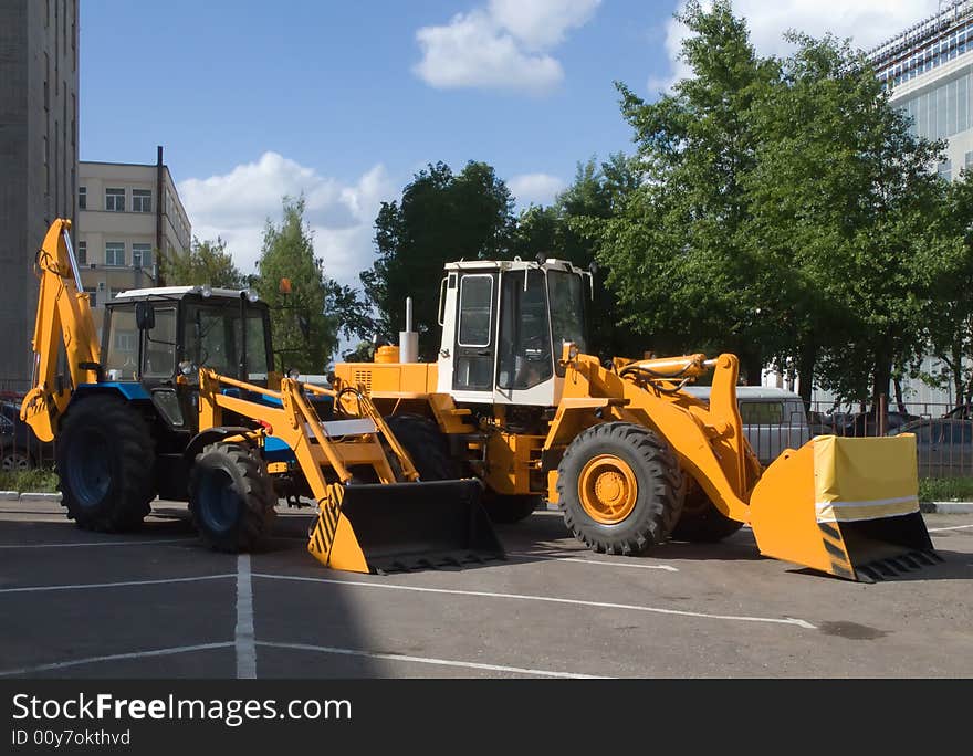 Two bulldozer on asphalt road. Two bulldozer on asphalt road